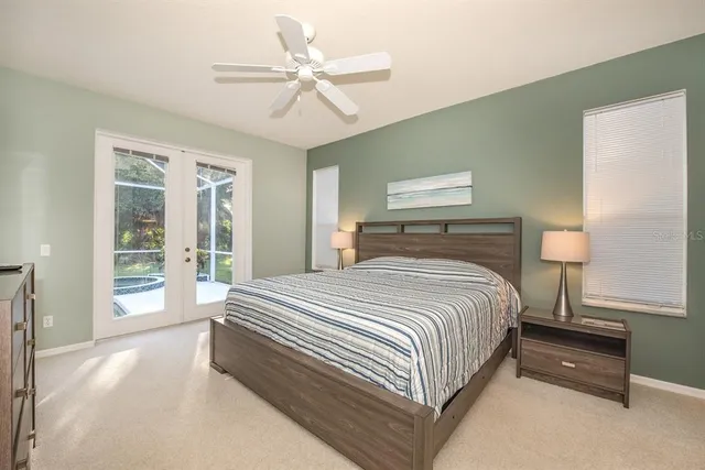 a spacious bedroom with a bed and a ceiling fan