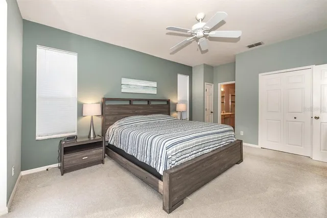 a bedroom with a large bed and a window