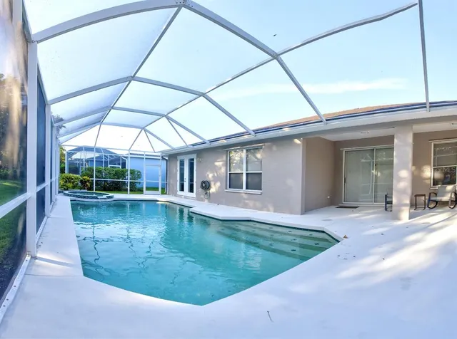a view of a patio with swimming pool table and chairs