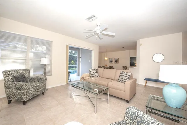 a living room with furniture a couch and potted plant
