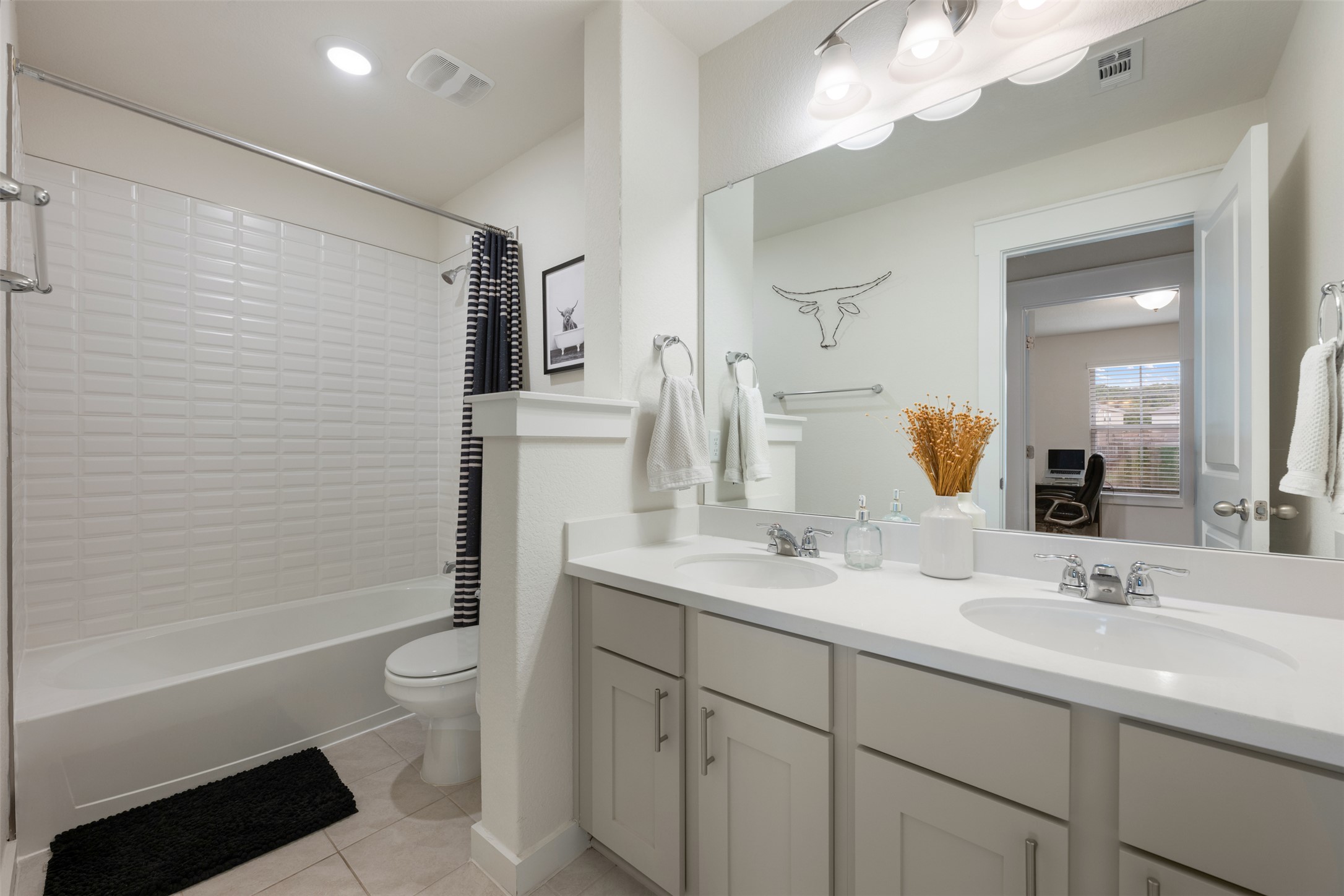 8204 Prairie Rye Drive Lago Vista, TX 78645 - Photo 22 of 39 Secondary bathroom with double sinks and upgraded tile.