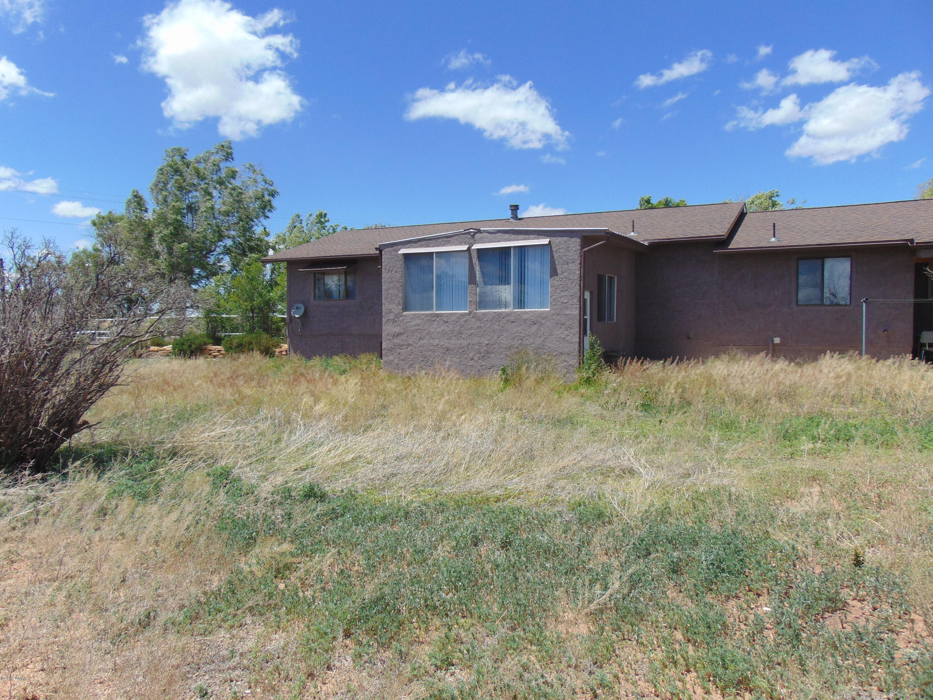 3135 Bourdon Ranch Road Taylor, AZ 85939 - Photo 54 of 61 a backyard of a house with table and chairs