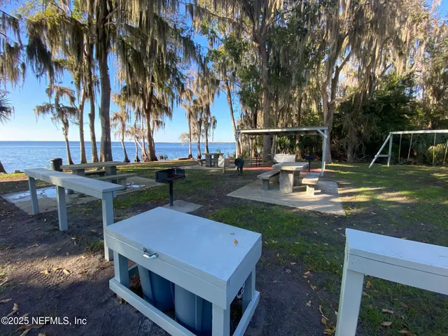 a view of a backyard with sitting area