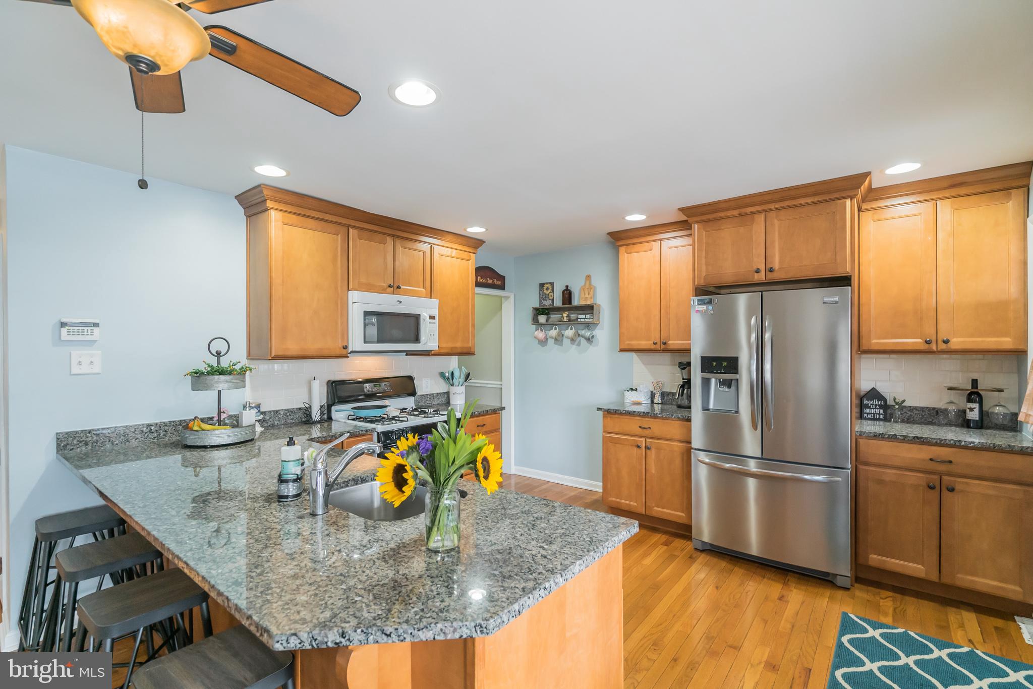 1432 Parklane Road Swarthmore, PA 19081 - Photo 11 of 19 a kitchen with stainless steel appliances granite countertop a sink refrigerator and microwave