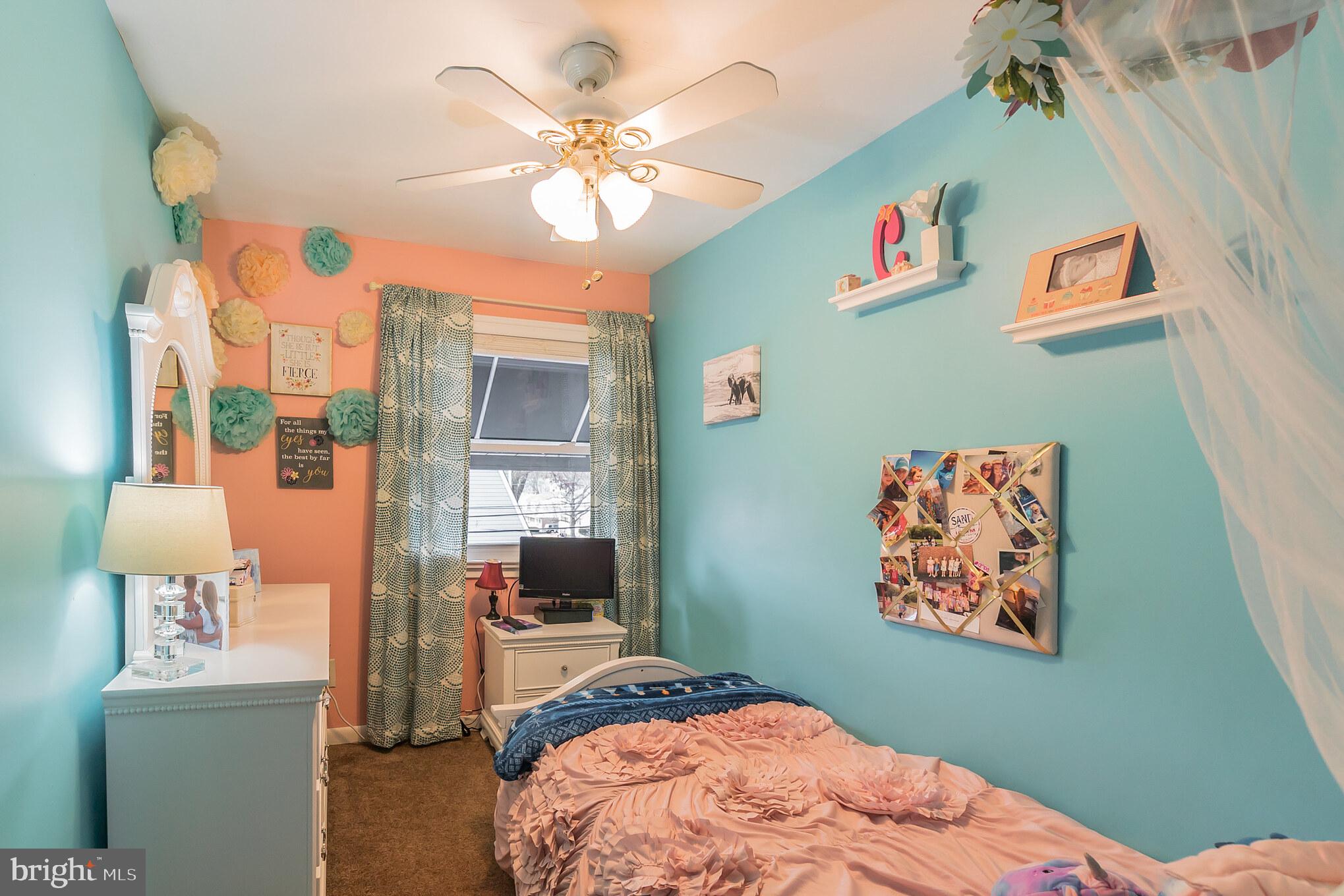 1432 Parklane Road Swarthmore, PA 19081 - Photo 16 of 19 a bedroom with a bed and a chandelier