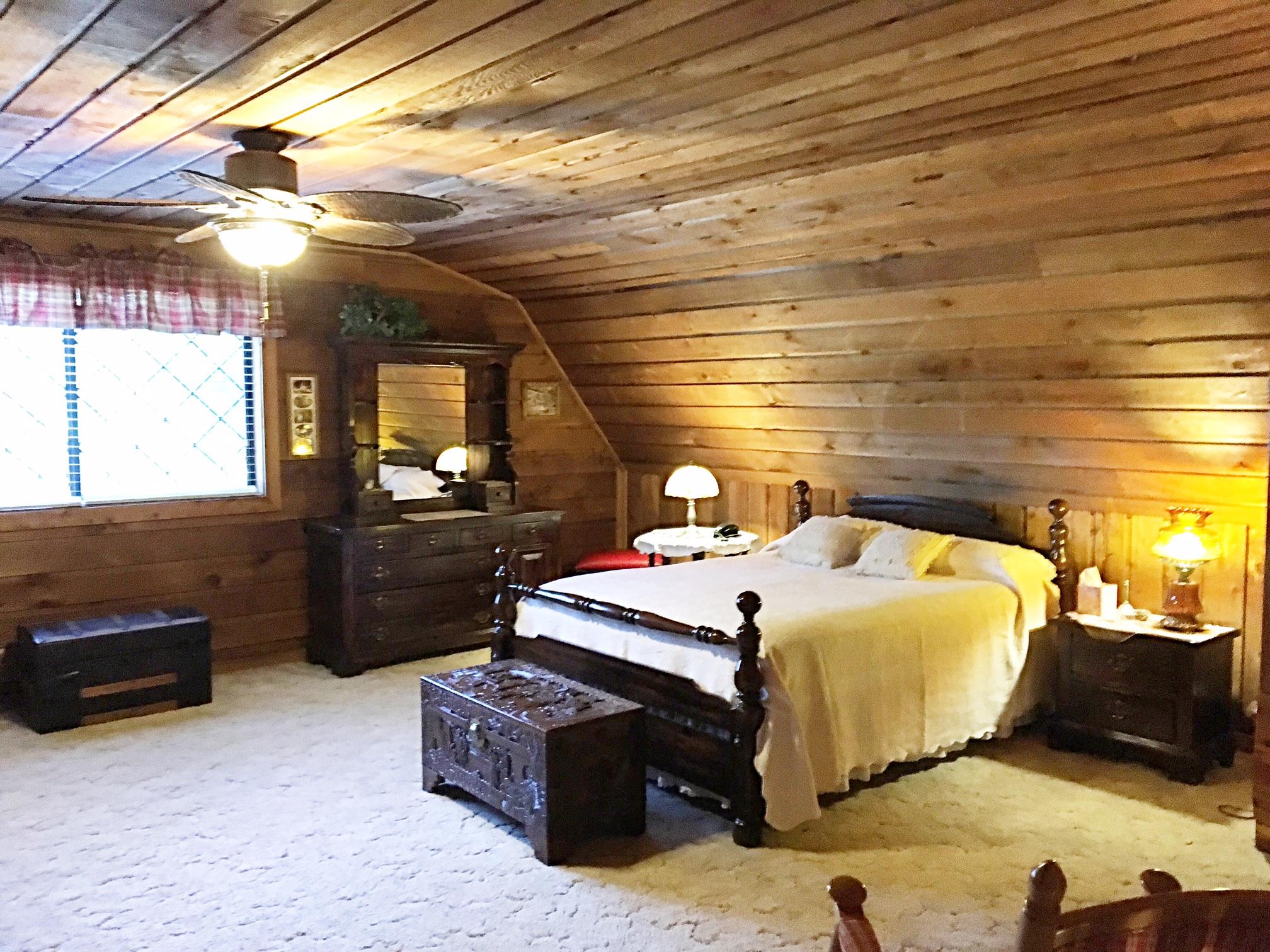 2731 New Hall Road Greenbrier, TN 37073 - Photo 19 of 30 a bedroom with a bed and a chandelier