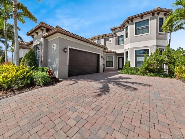 a front view of a house with a yard and a garden