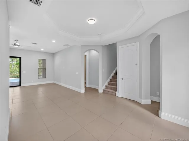 a view of a room with a chandelier furniture and kitchen view