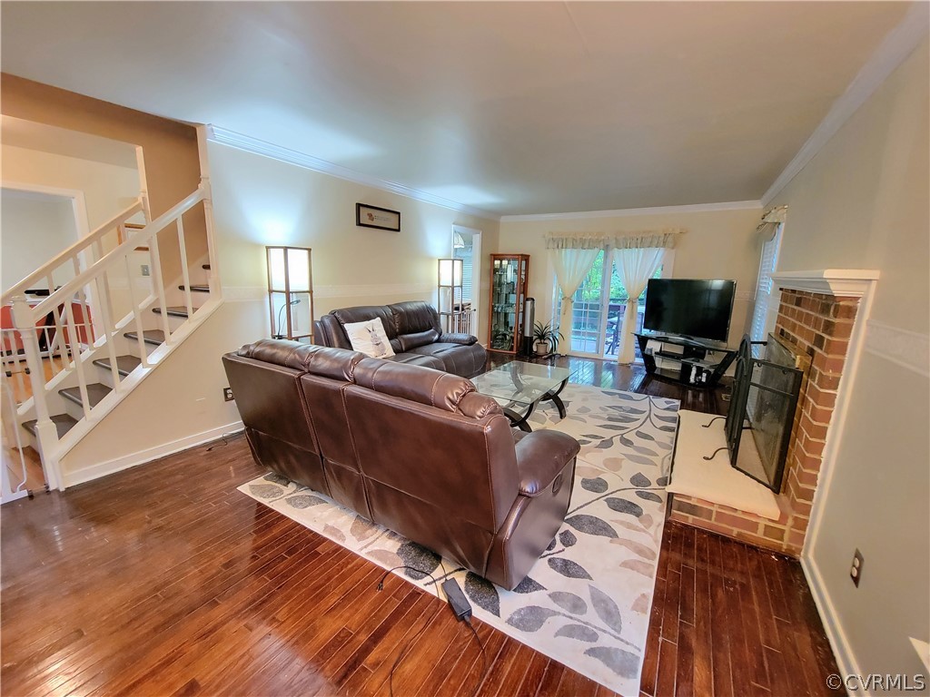 5814 Laurel Trail Road Midlothian, VA 23112 - Photo 13 of 34 a living room with furniture a flat screen tv and a fireplace