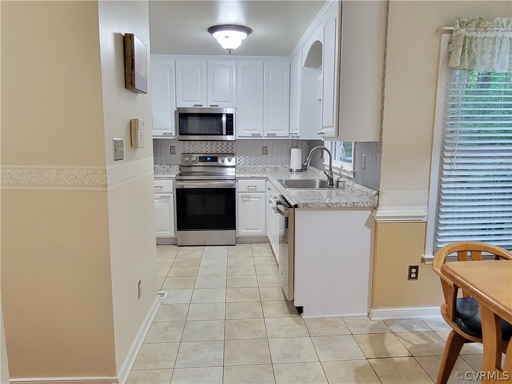 5814 Laurel Trail Road Midlothian, VA 23112 - Photo 16 of 34 a kitchen with stainless steel appliances granite countertop a stove sink and microwave