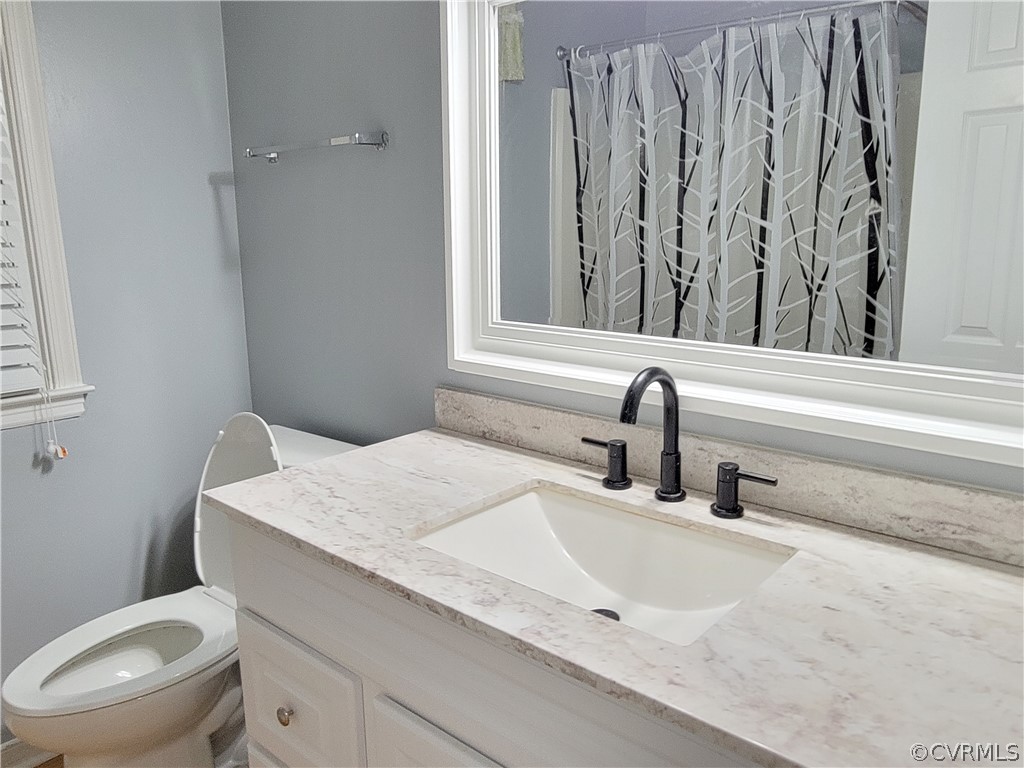 5814 Laurel Trail Road Midlothian, VA 23112 - Photo 18 of 34 a bathroom with a granite countertop sink and a toilet