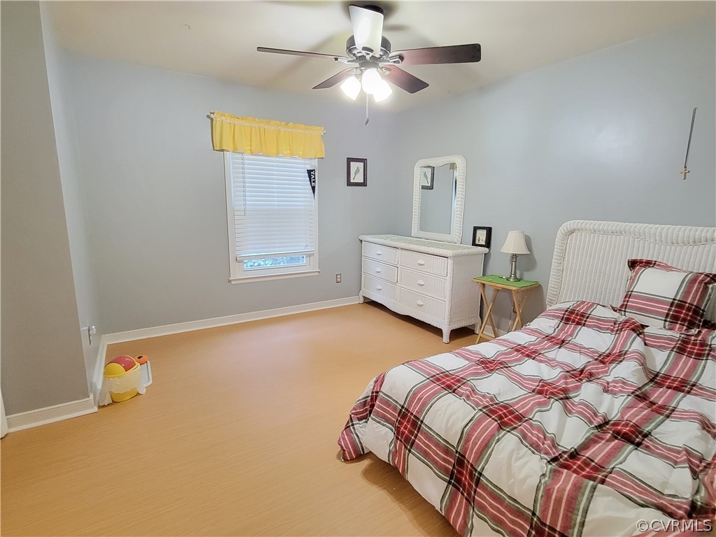 5814 Laurel Trail Road Midlothian, VA 23112 - Photo 25 of 34 a bedroom with a bed and a chandelier