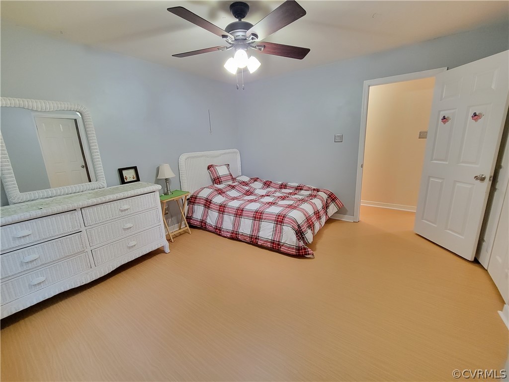 5814 Laurel Trail Road Midlothian, VA 23112 - Photo 27 of 34 a bedroom with a bed and a chandelier