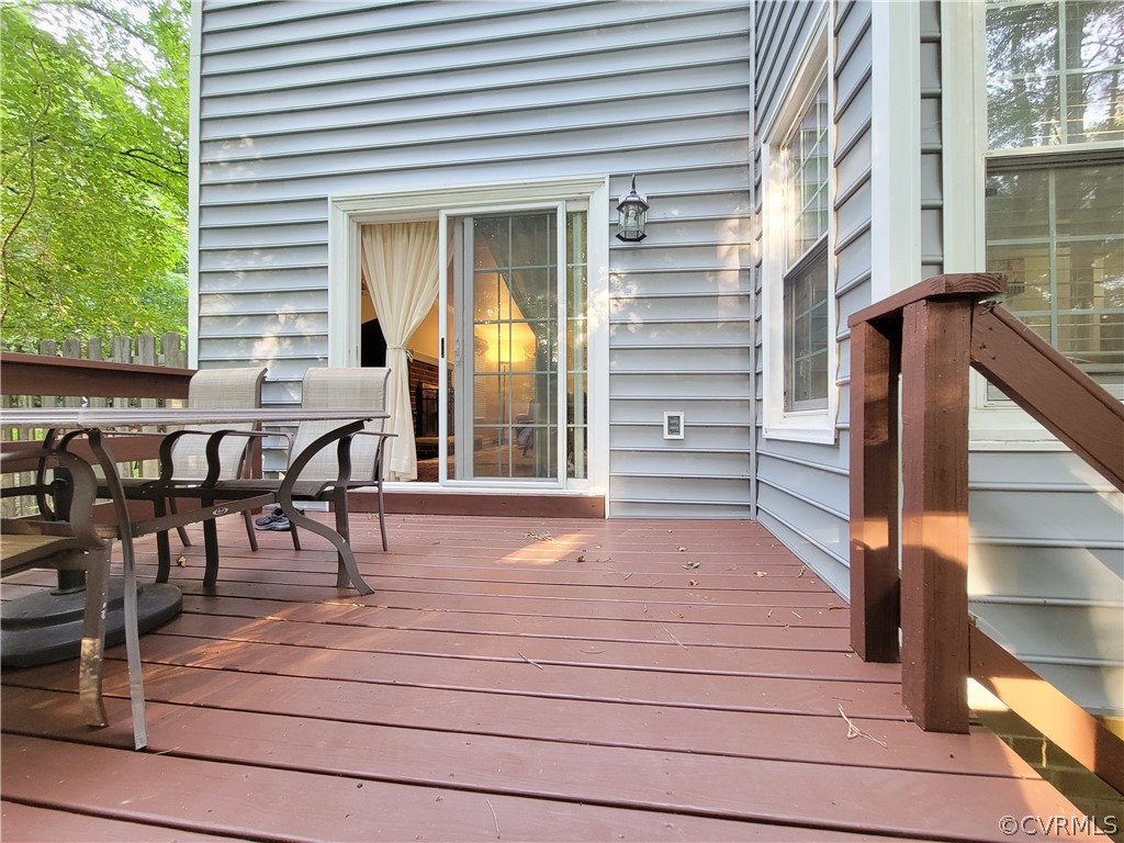 5814 Laurel Trail Road Midlothian, VA 23112 - Photo 31 of 34 a view of a deck with table and chairs with wooden floor and fence