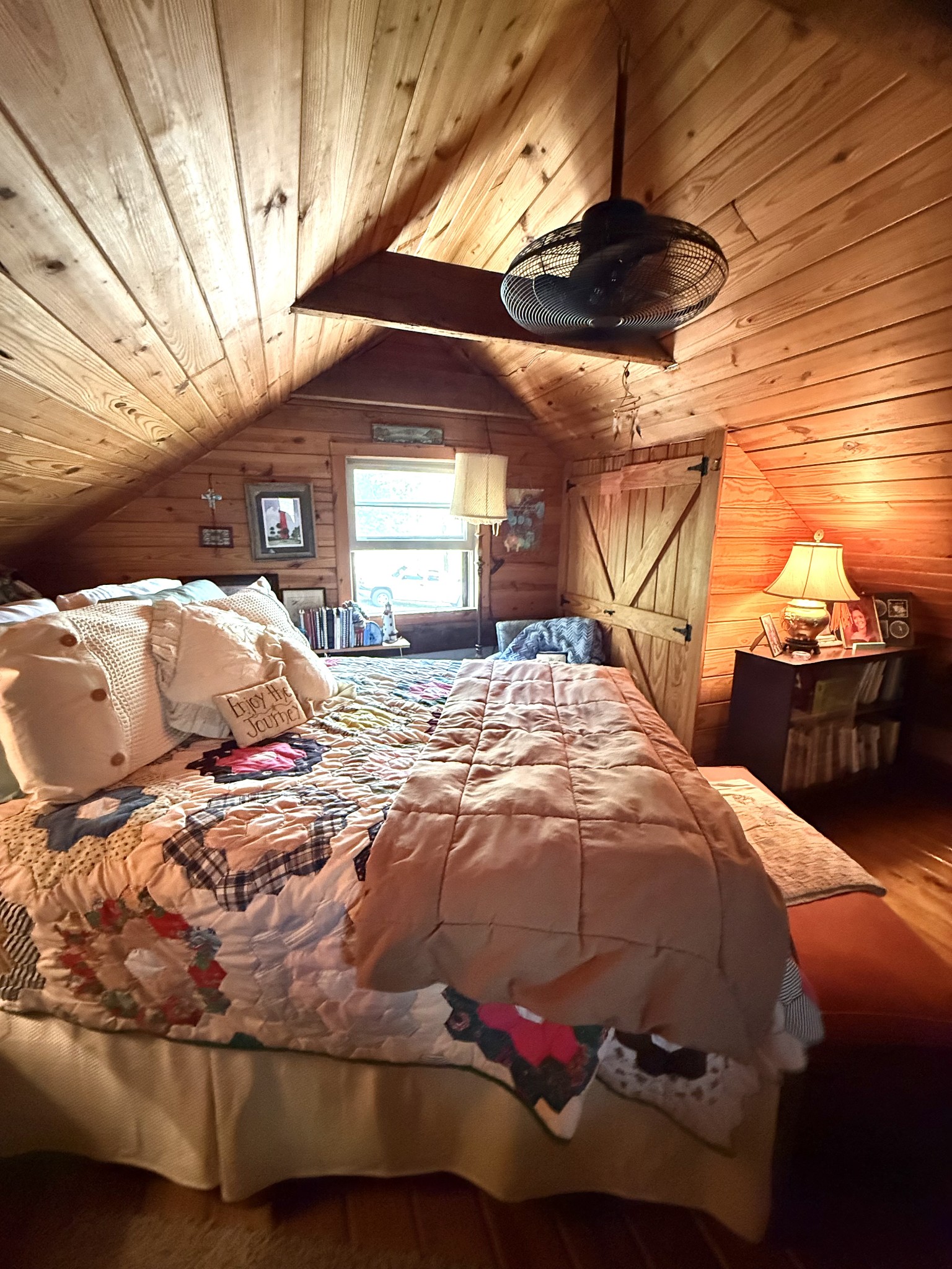 562 Junus Jackson Hollow Road Minor Hill, TN 38473 - Photo 57 of 72 a bedroom with a bed and a chandelier
