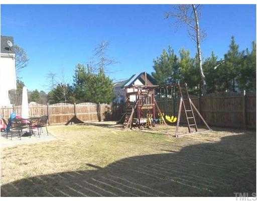6028 Brambleberry Way Raleigh, NC 27616 - Photo 11 of 12 Huge fenced in back yard with playground. Also features a double sized patio for inviting guests over when grilling "Southern BBQ".