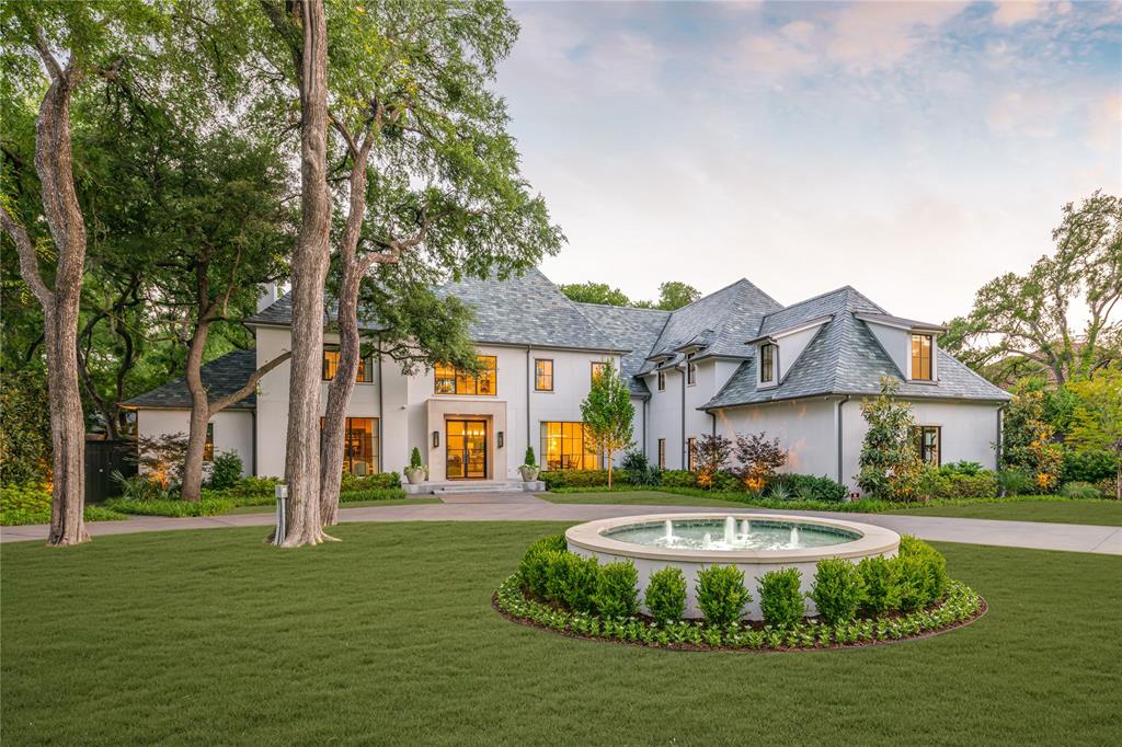 a front view of a house with a yard table and chairs