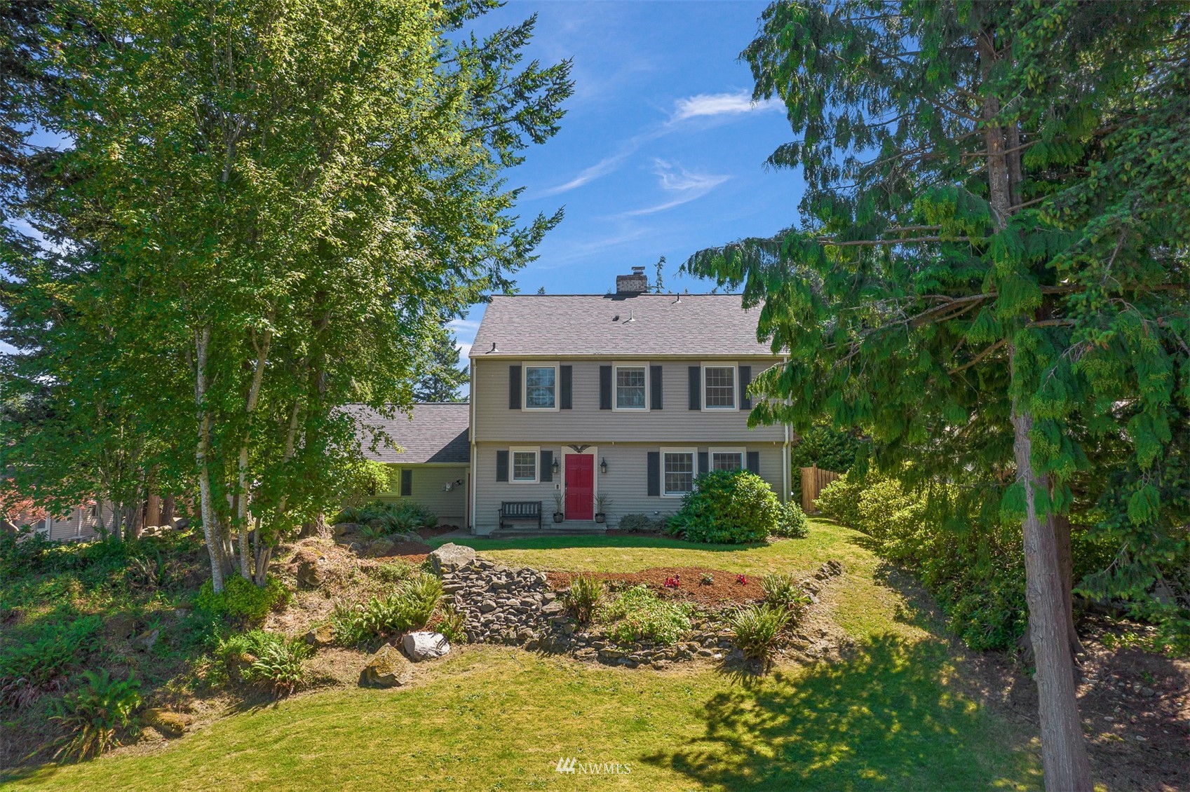 622 Everglade Road Bellingham, WA 98225 - Photo 1 of 38 a front view of a house with a yard fountain and large tree