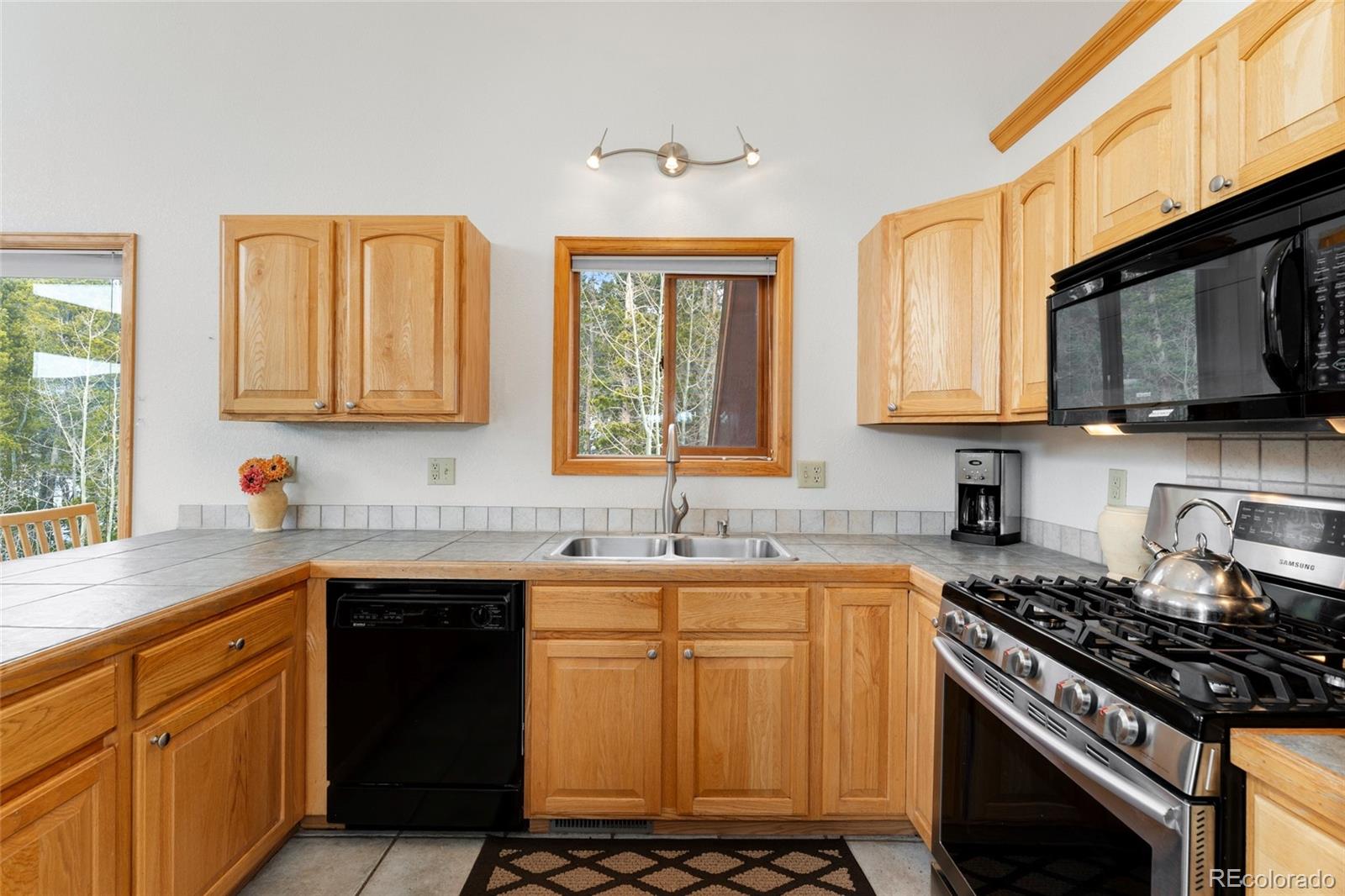 660 Coyote Circle Black Hawk, CO 80422 - Photo 11 of 46 a kitchen with stainless steel appliances a sink stove and microwave