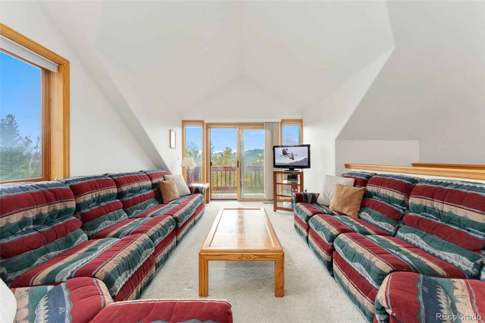 660 Coyote Circle Black Hawk, CO 80422 - Photo 13 of 46 a living room with furniture and a book shelf