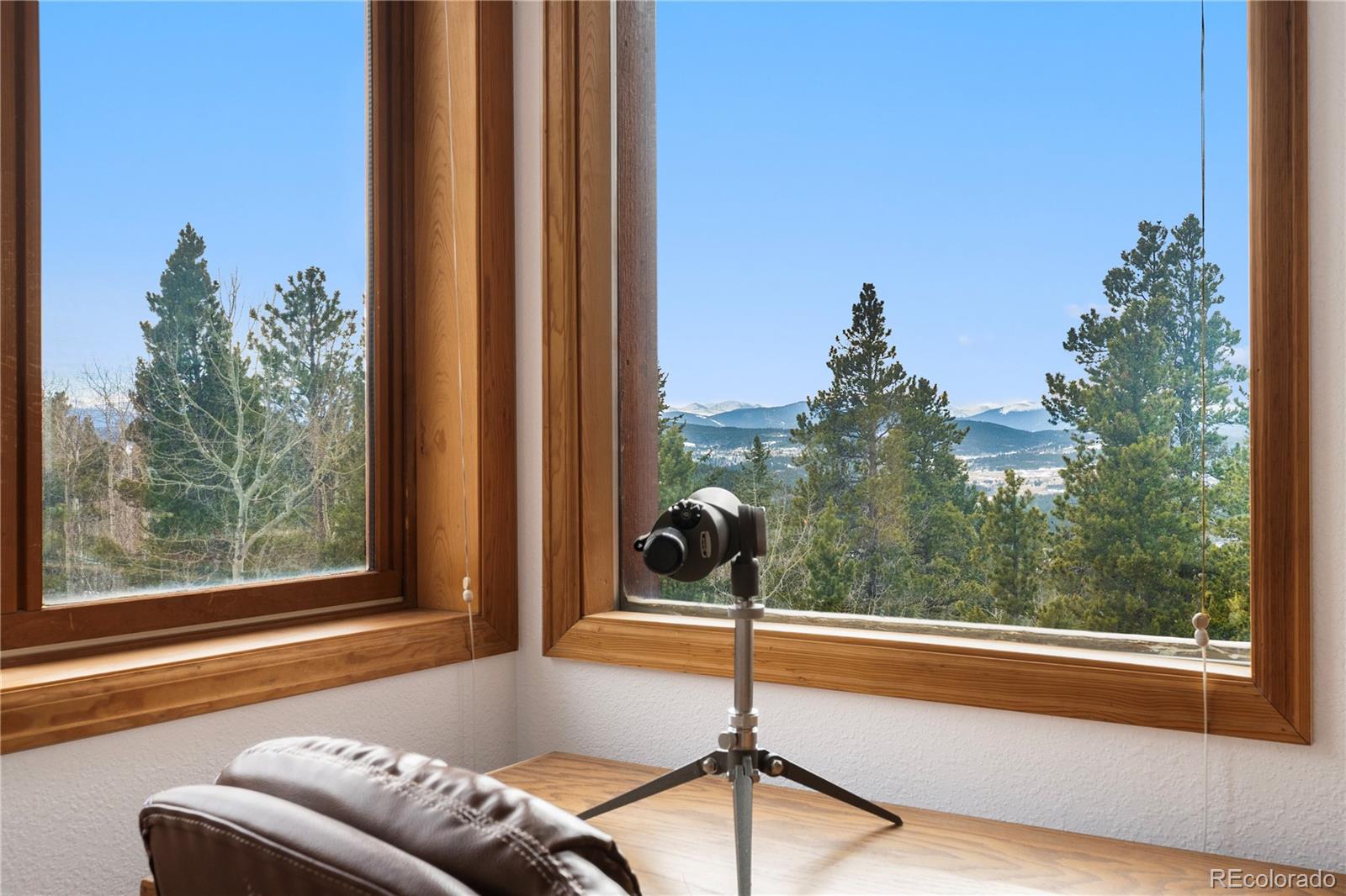 660 Coyote Circle Black Hawk, CO 80422 - Photo 14 of 46 a living room filled with furniture and a floor to ceiling window