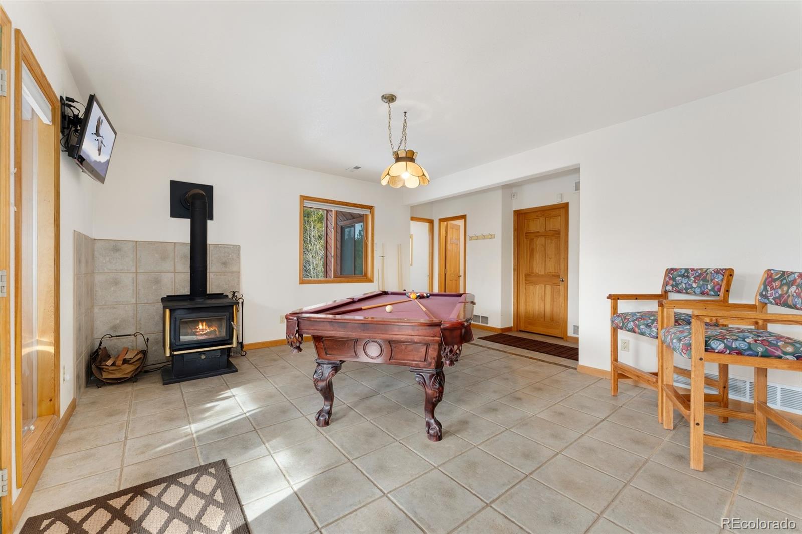 660 Coyote Circle Black Hawk, CO 80422 - Photo 15 of 46 a living room with furniture a window and a fireplace
