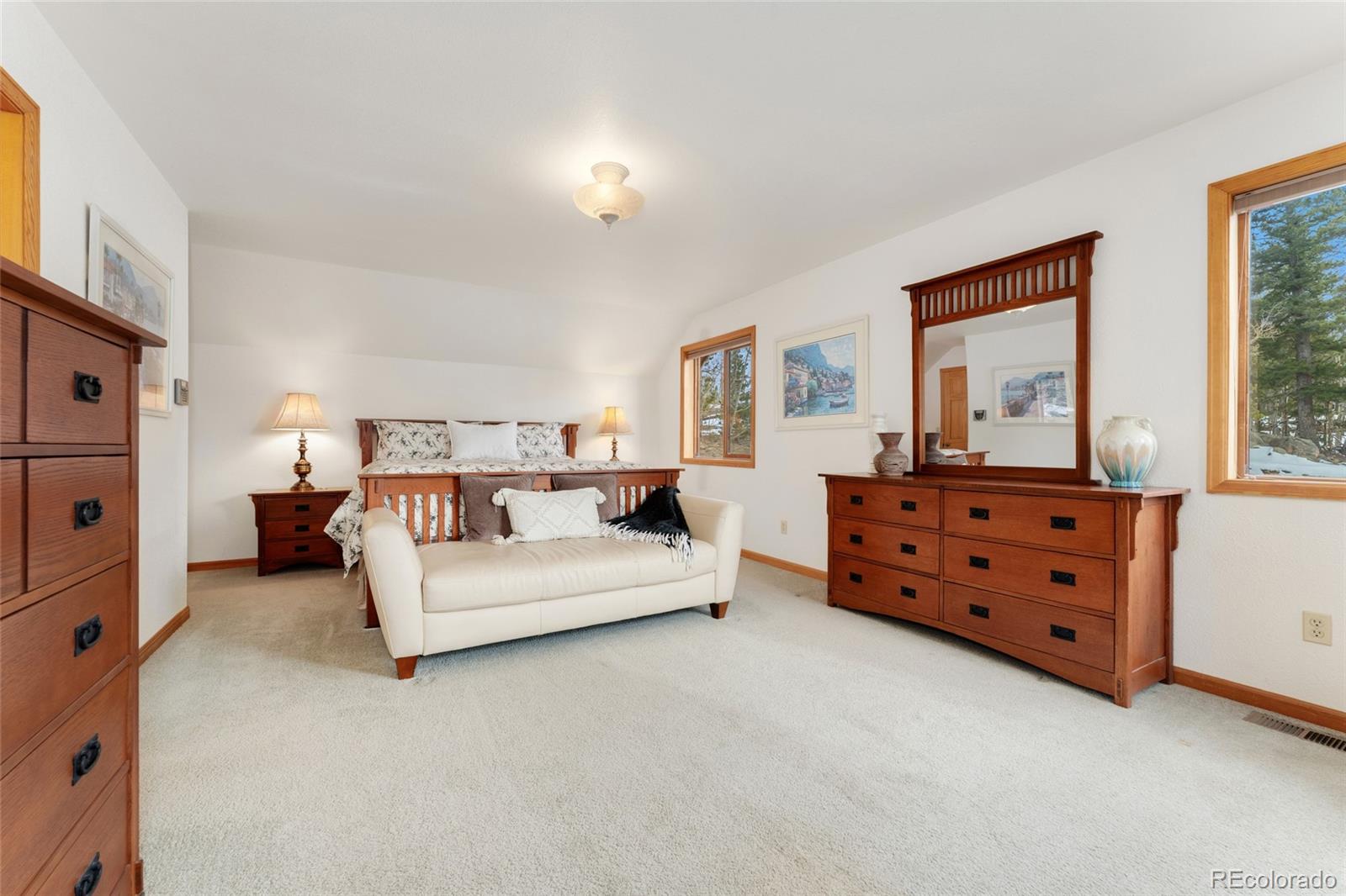 660 Coyote Circle Black Hawk, CO 80422 - Photo 18 of 46 a spacious bedroom with a bed and a dresser