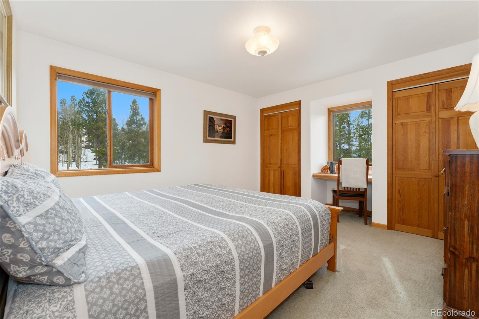 660 Coyote Circle Black Hawk, CO 80422 - Photo 24 of 46 a bedroom with a large bed and a large window