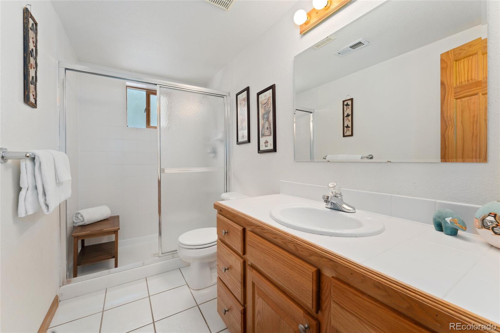 660 Coyote Circle Black Hawk, CO 80422 - Photo 29 of 46 a bathroom with a sink a toilet and mirror
