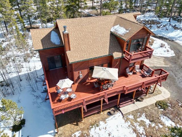 660 Coyote Circle Black Hawk, CO 80422 - Photo 37 of 46 an aerial view of a house with wooden deck and outdoor seating