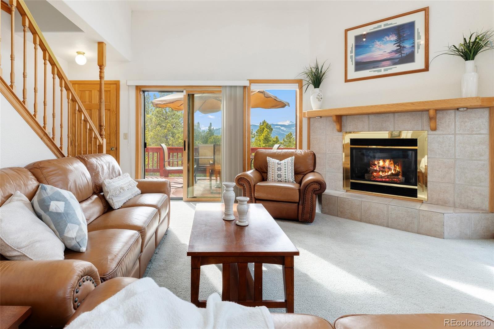 660 Coyote Circle Black Hawk, CO 80422 - Photo 5 of 46 a living room with furniture large window and a fireplace