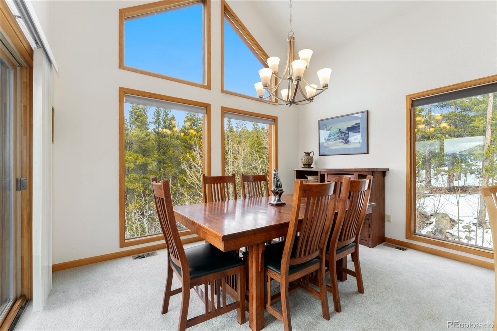 660 Coyote Circle Black Hawk, CO 80422 - Photo 9 of 46 a dining room with furniture a large window and a chandelier
