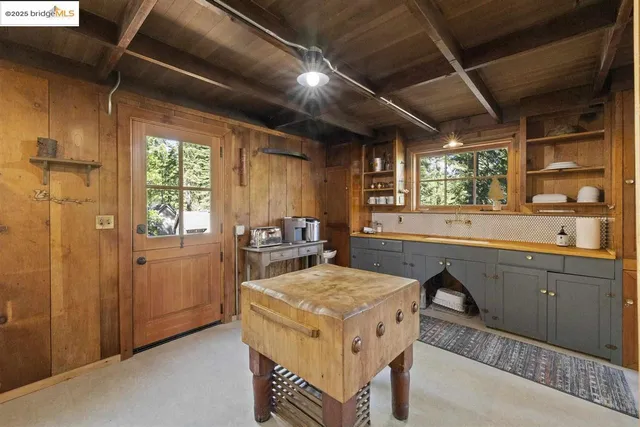 a kitchen that has a stove and a table in it