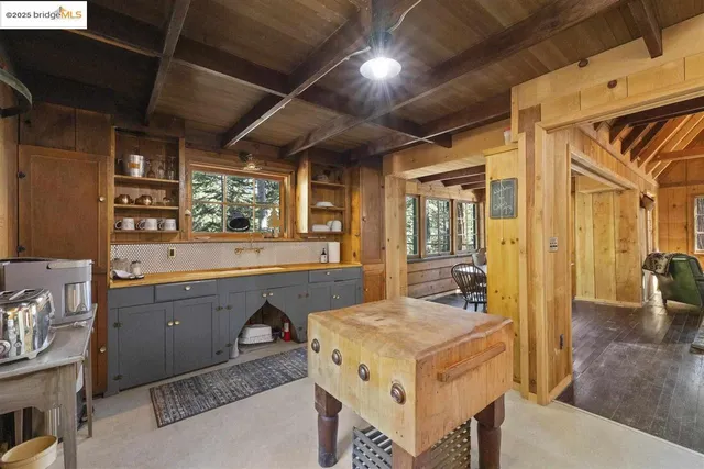 a kitchen with a stove a refrigerator a sink and wooden cabinets