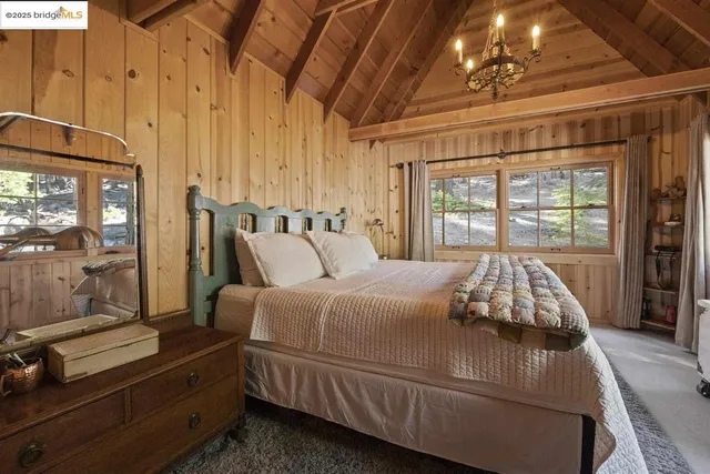 a bed sitting in a bedroom next to a window