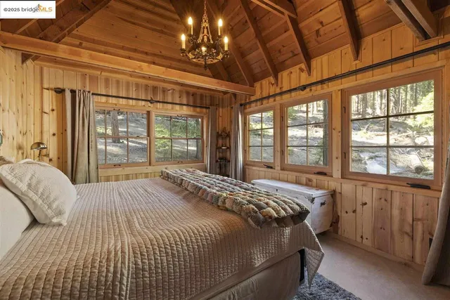 a bedroom with a large bed and a large window