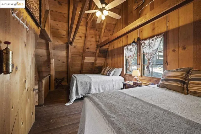 a bedroom with two beds and a chandelier