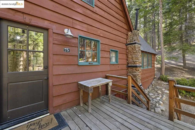 a view of a house with wooden deck