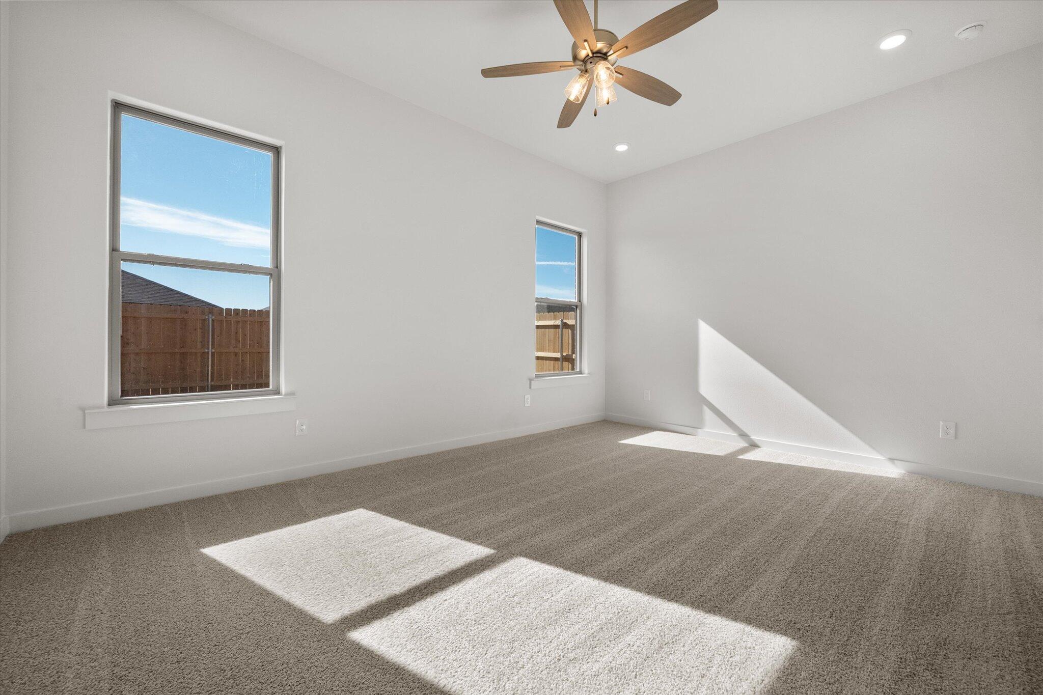 3003 138th Place Lubbock, TX 79423 - Photo 11 of 21 an empty room with windows and fan