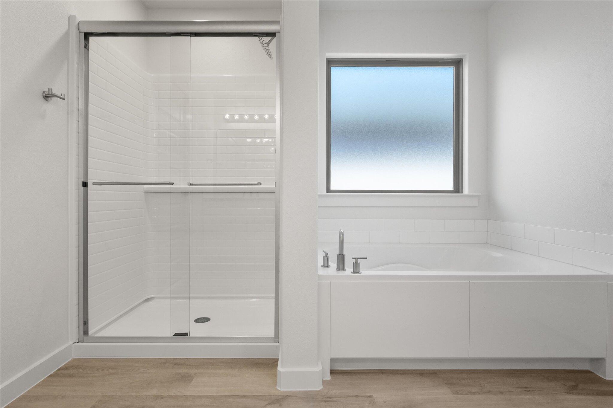 3003 138th Place Lubbock, TX 79423 - Photo 14 of 21 a bathroom with a bathtub and a shower
