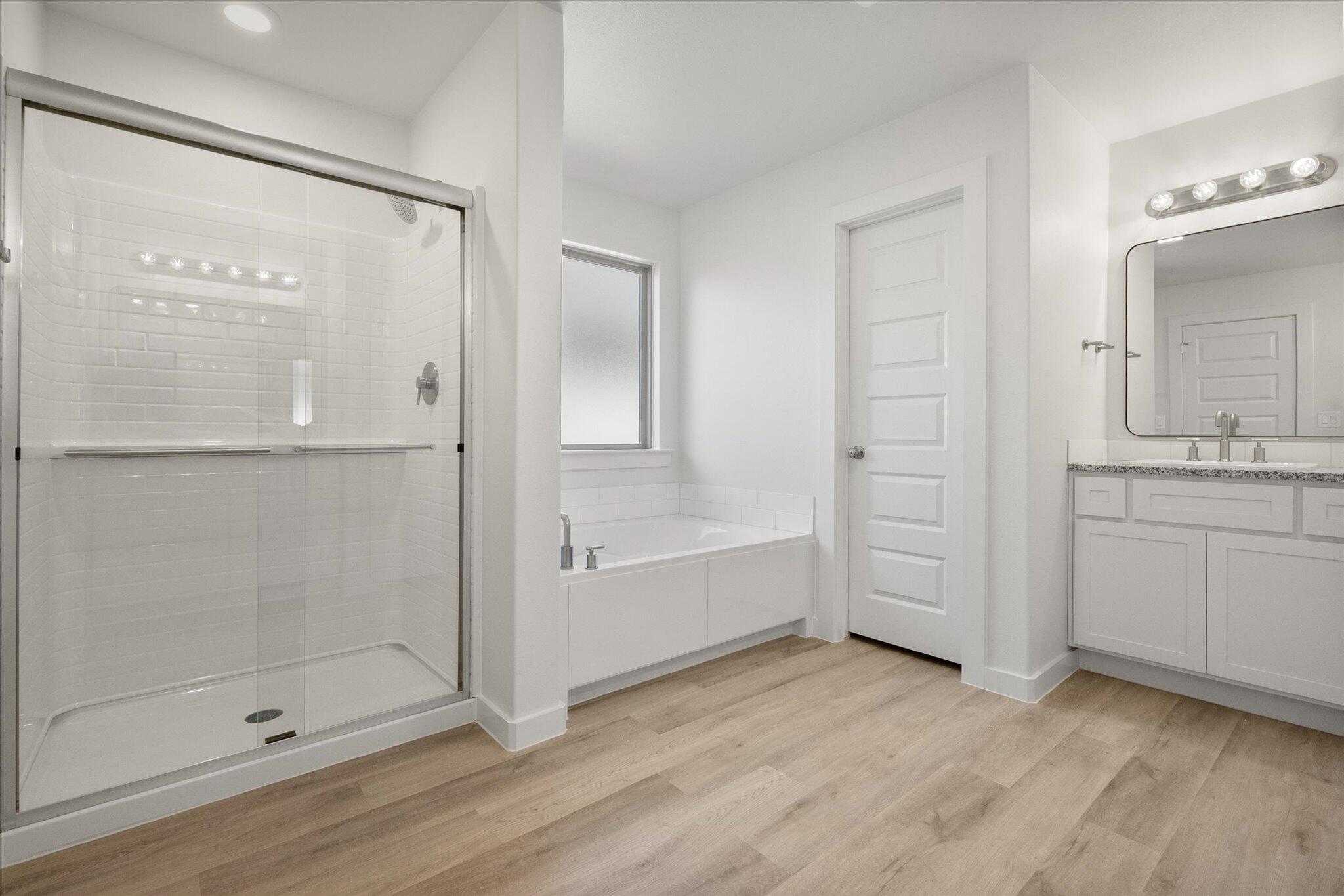 3003 138th Place Lubbock, TX 79423 - Photo 16 of 21 a bathroom with a bathtub and a shower