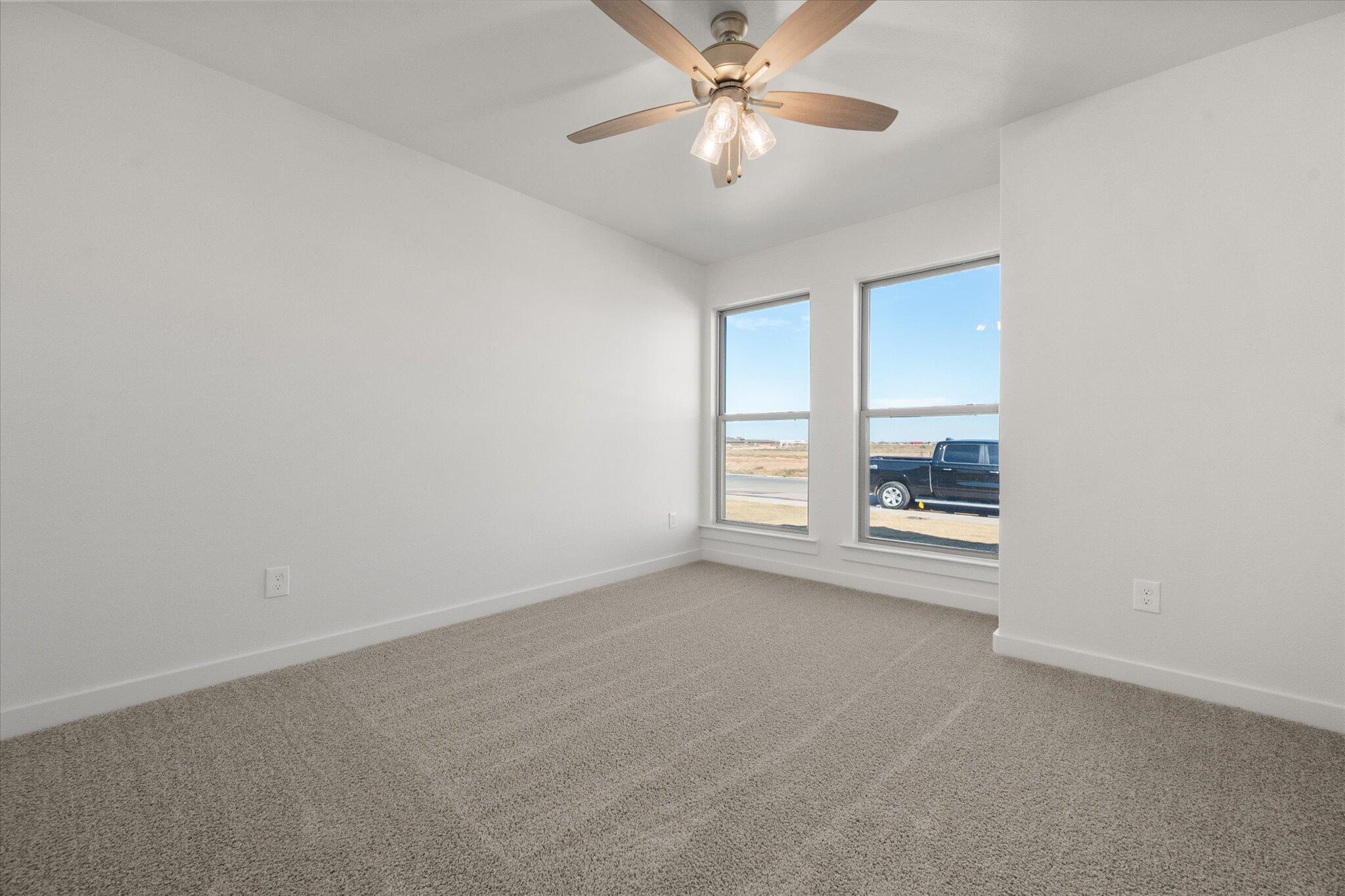 3003 138th Place Lubbock, TX 79423 - Photo 17 of 21 an empty room with windows and fan