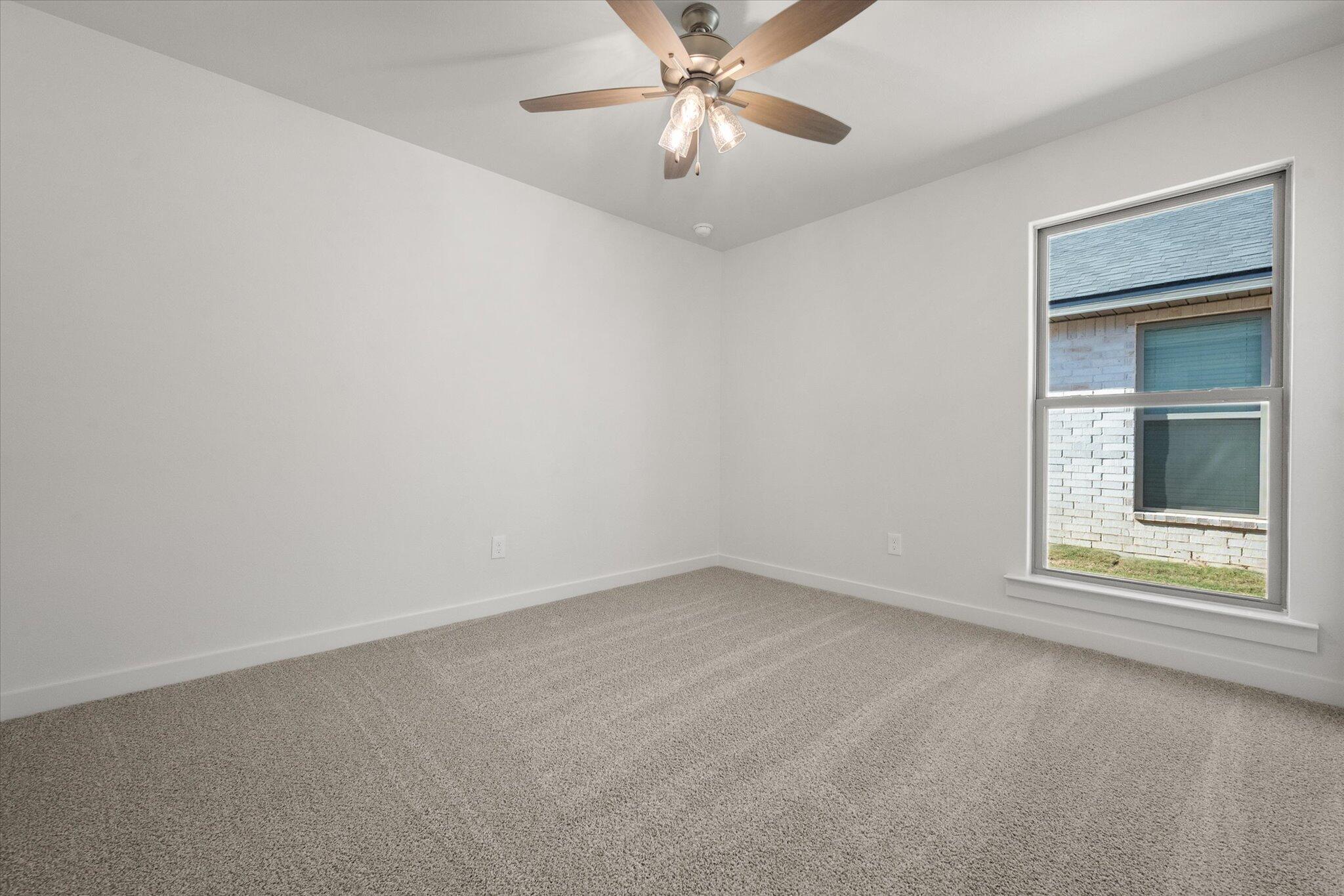 3003 138th Place Lubbock, TX 79423 - Photo 18 of 21 an empty room with a window and a ceiling fan