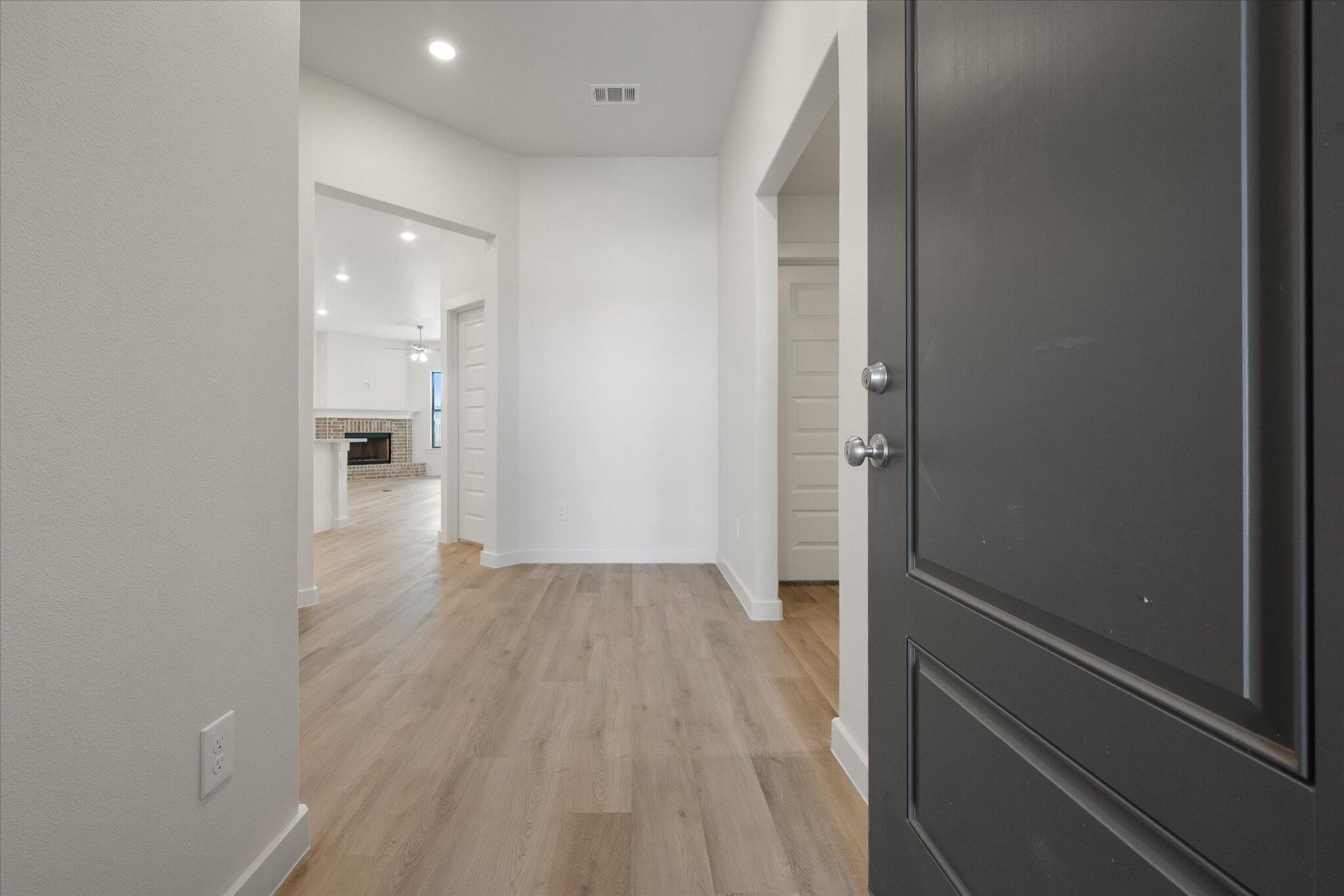 3003 138th Place Lubbock, TX 79423 - Photo 2 of 21 a view of a hallway with wooden floor and a bathroom