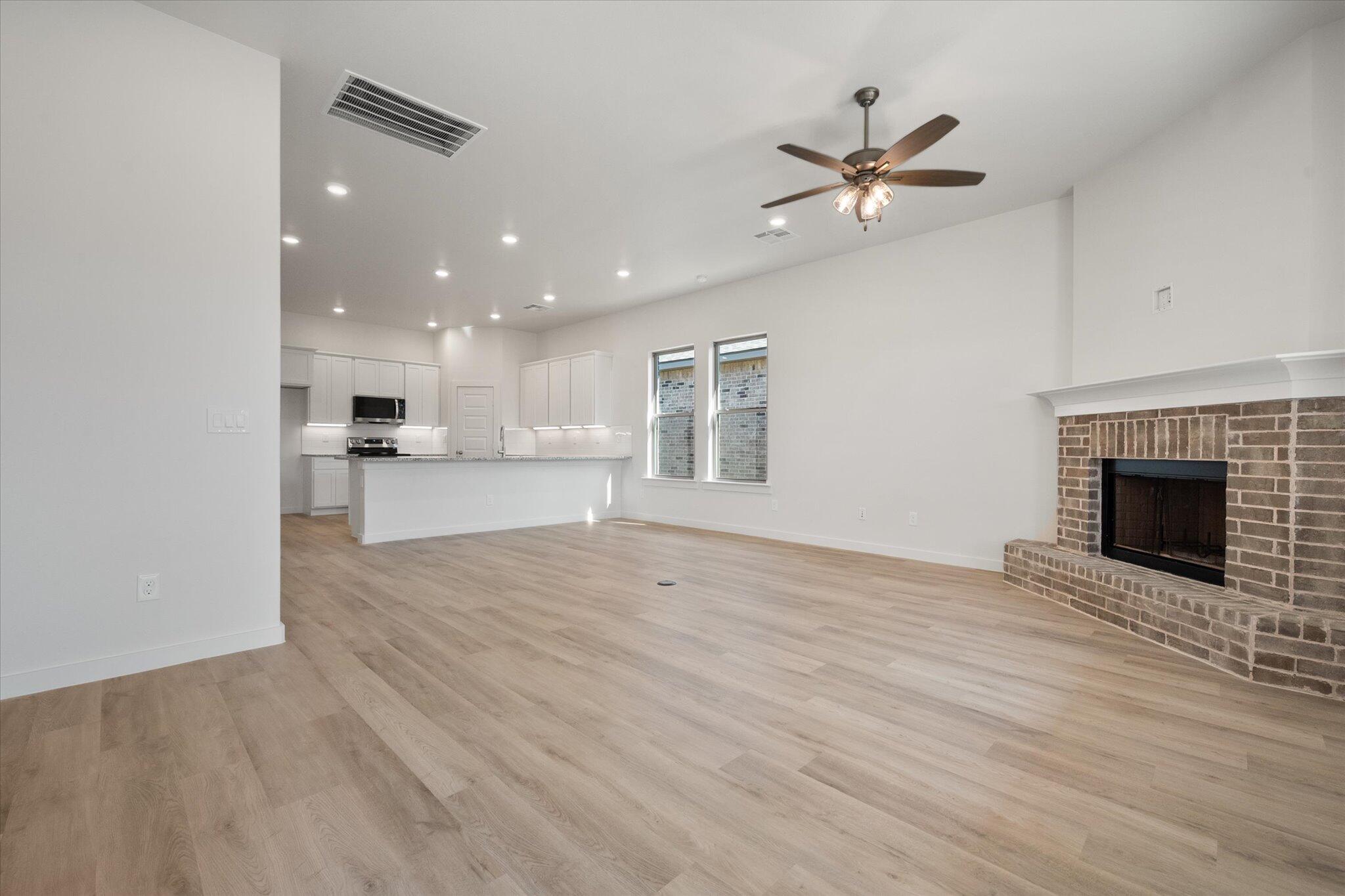 3003 138th Place Lubbock, TX 79423 - Photo 10 of 21 a view of an empty room with a kitchen and a window