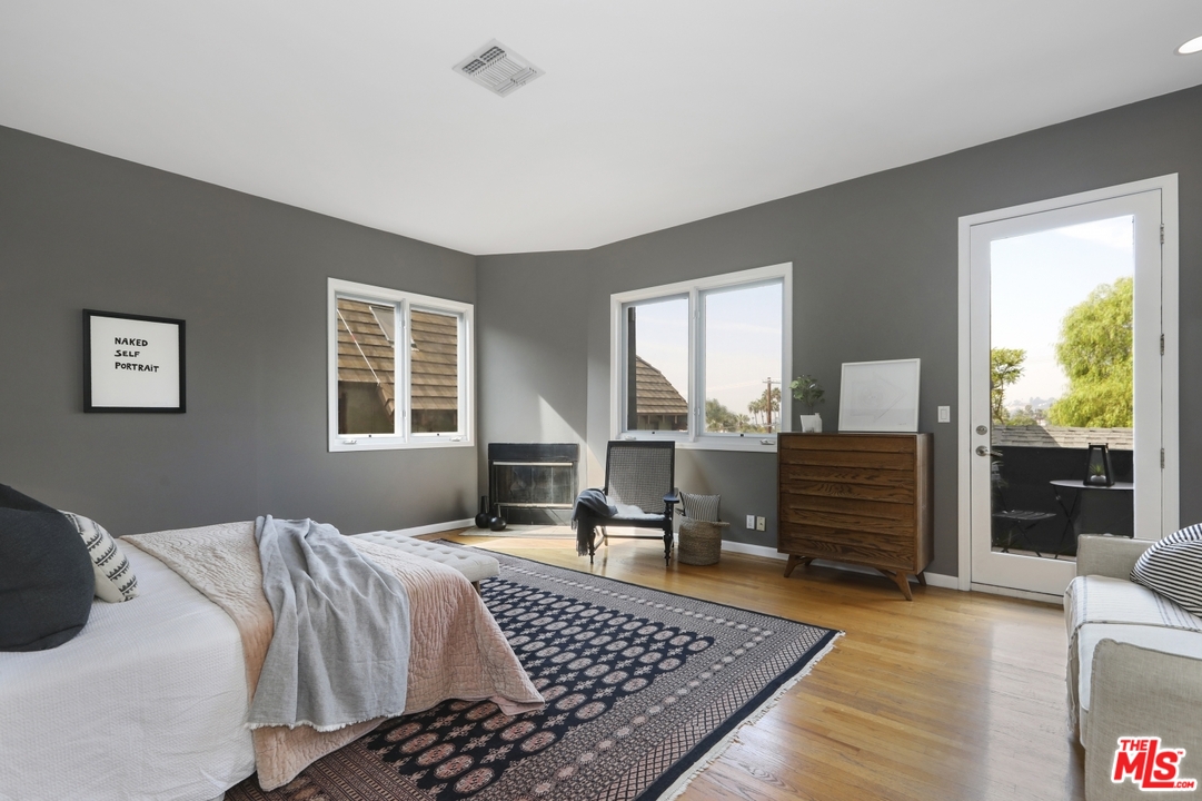 4357 Cedarhurst Circle Los Angeles, CA 90027 - Photo 24 of 51 a bedroom with a bed and wooden floor