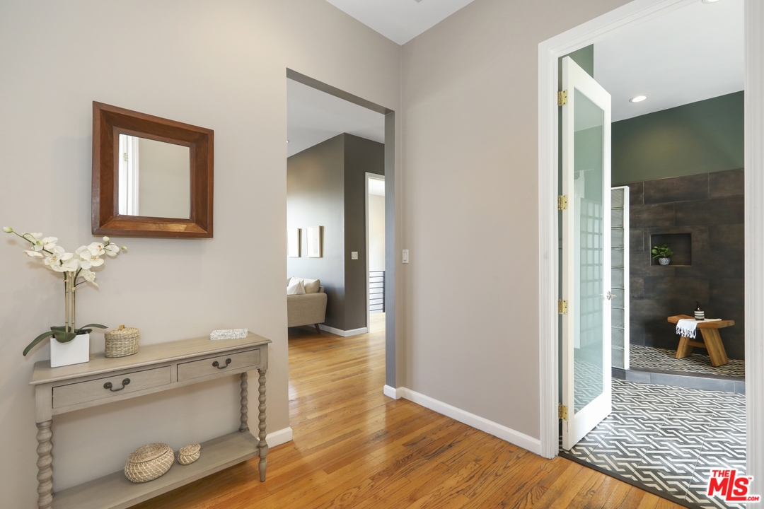 4357 Cedarhurst Circle Los Angeles, CA 90027 - Photo 27 of 51 a view of a hallway with wooden floor and a bathroom