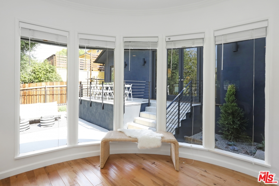 4357 Cedarhurst Circle Los Angeles, CA 90027 - Photo 35 of 51 a living room with hardwood floor and a floor to ceiling window