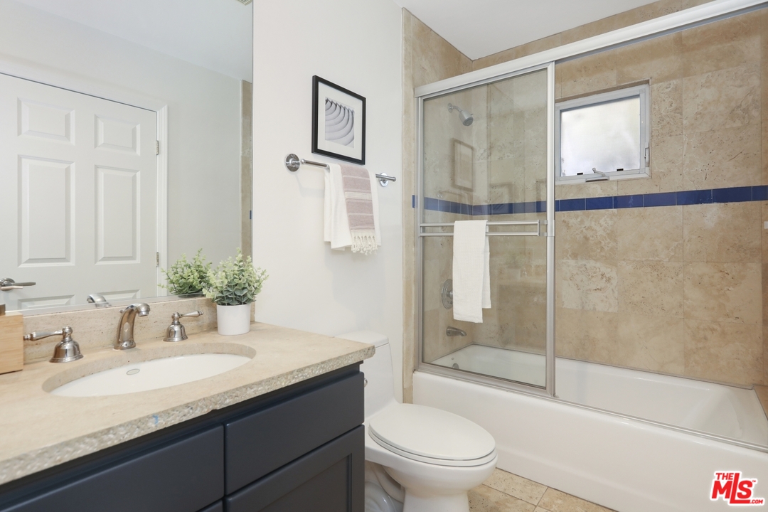 4357 Cedarhurst Circle Los Angeles, CA 90027 - Photo 49 of 51 a bathroom with a granite countertop sink toilet and shower