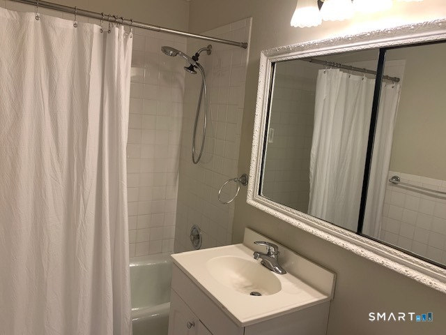 50 Glenbrook Road, Unit 5G Stamford, CT 06902 - Photo 33 of 40 a bathroom with a sink a mirror and a shower